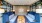 a room with blue couches and a rug