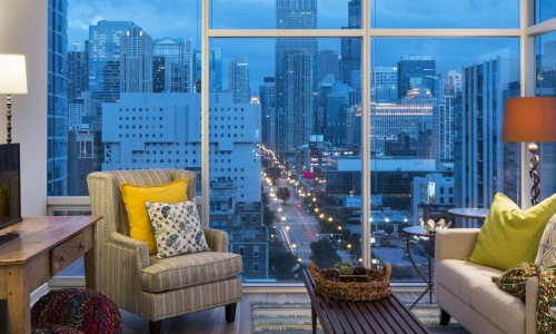 a living room with a view of the city