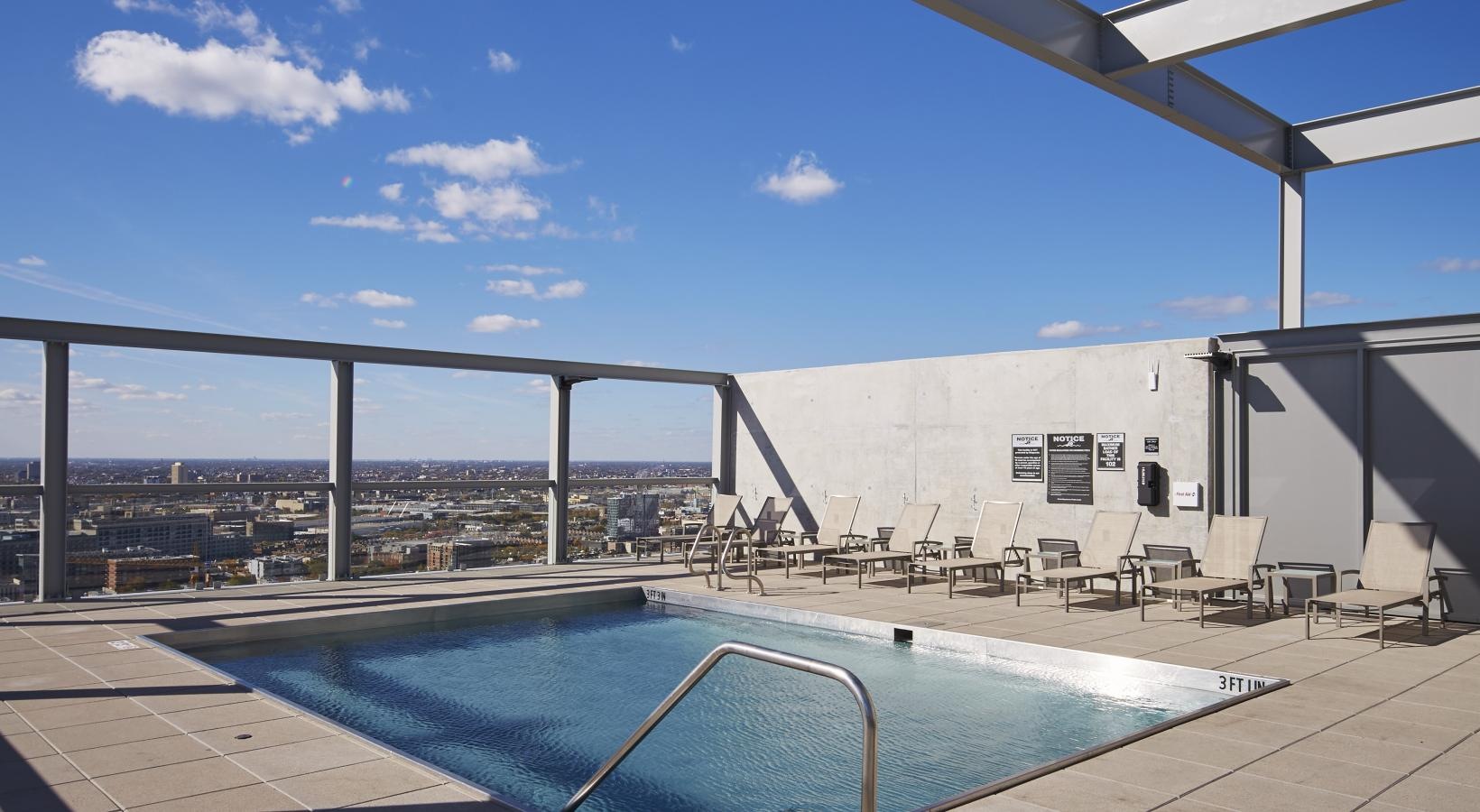 Relax and unwind poolside a swimming pool with a bridge in the background
