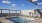 a swimming pool with a bridge in the background