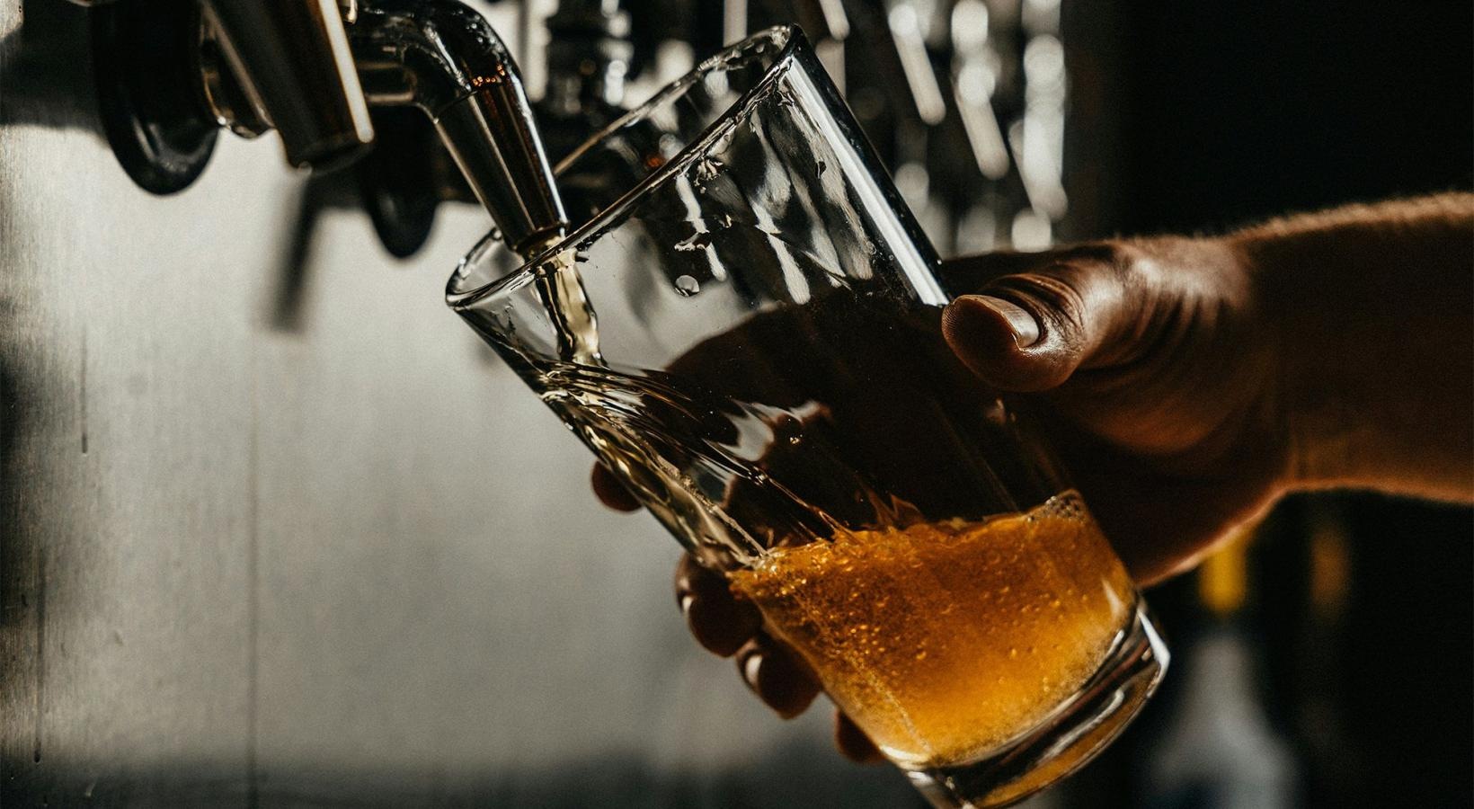 Bustling community with plenty of dining choices someone pouring a glass of beer