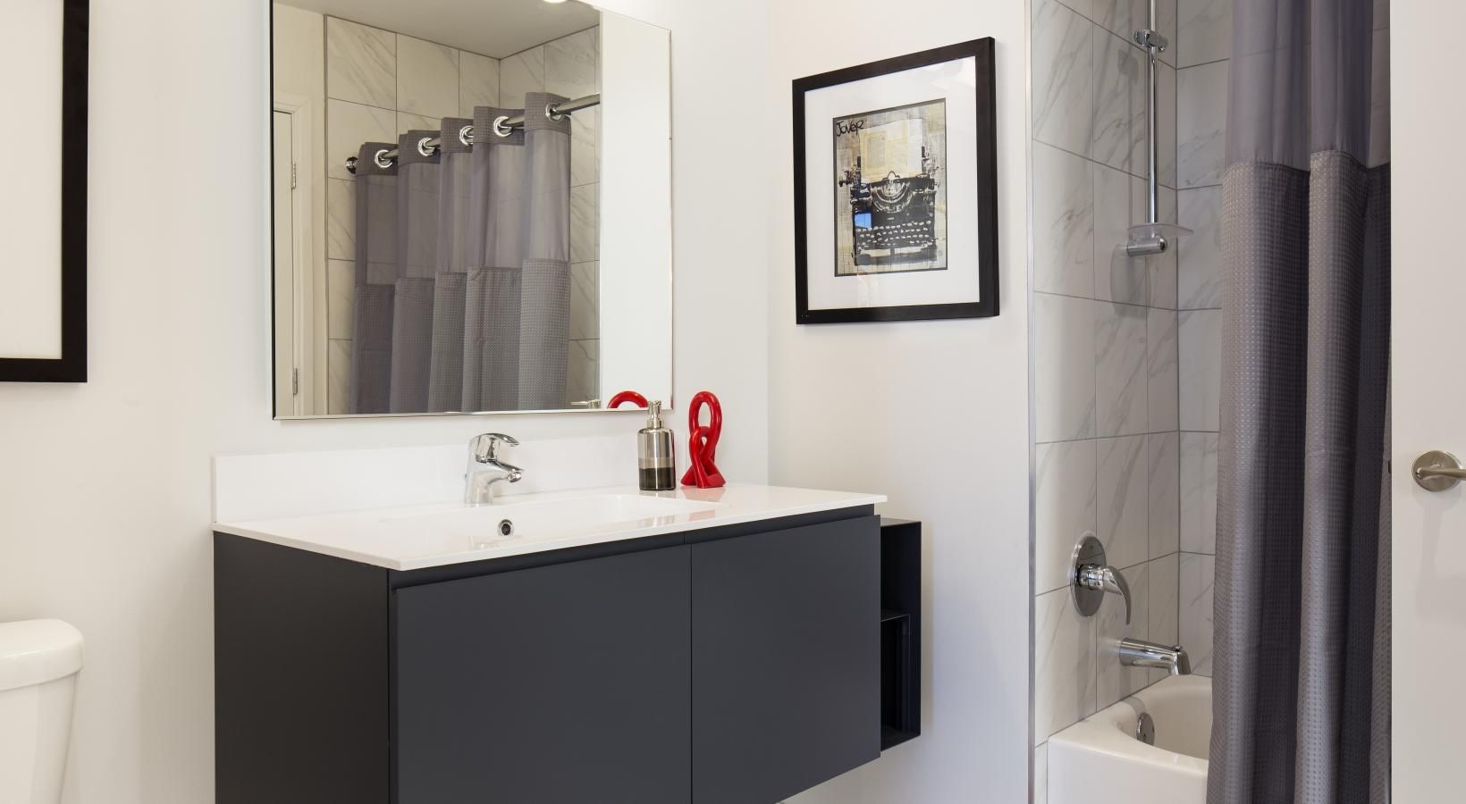 Spacious bathrooms with everything you need a bathroom with a sink and a mirror