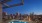 a pool with a city skyline in the background